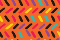 Colorful candy sprinkle pattern on an orange background