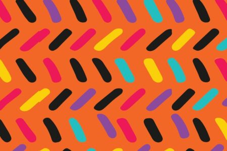 Colorful candy sprinkle pattern on an orange background
