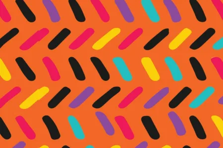 Colorful candy sprinkle pattern on an orange background